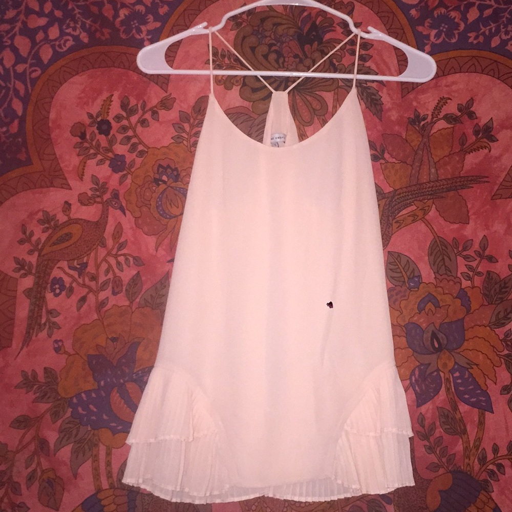 Light pink shirt.